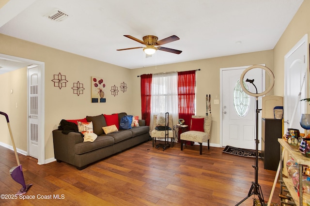 living room featuring ceiling fan and dark hardwood / wood-style floors