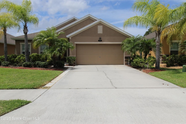 view of front of home featuring a garage and a front lawn