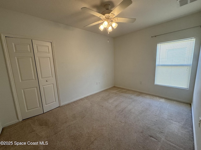 empty room with light carpet and ceiling fan