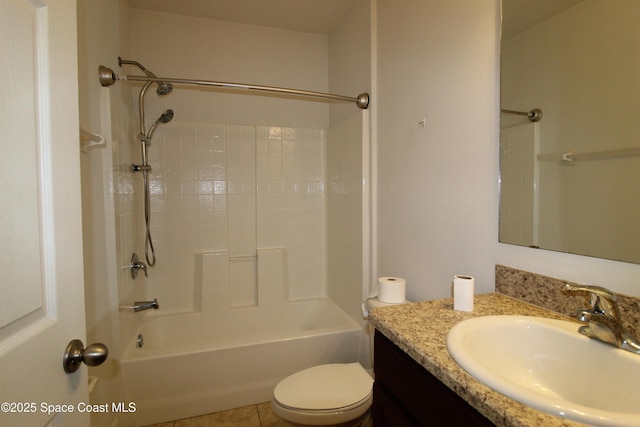 full bathroom with shower / tub combination, vanity, tile patterned floors, and toilet