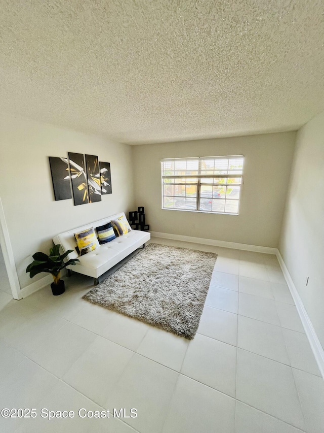 tiled living room featuring a textured ceiling