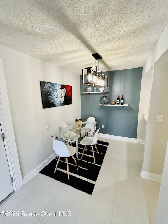 dining room featuring tile patterned floors and a textured ceiling