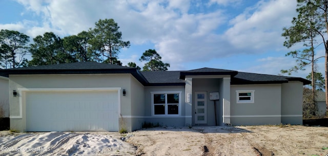 prairie-style home featuring a garage