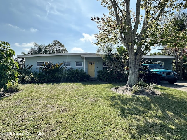 single story home featuring a front lawn and a carport