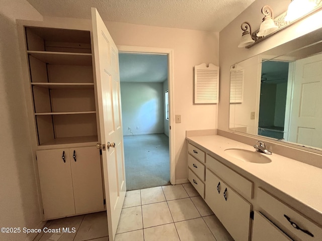 bathroom with vanity, tile patterned flooring, and a textured ceiling