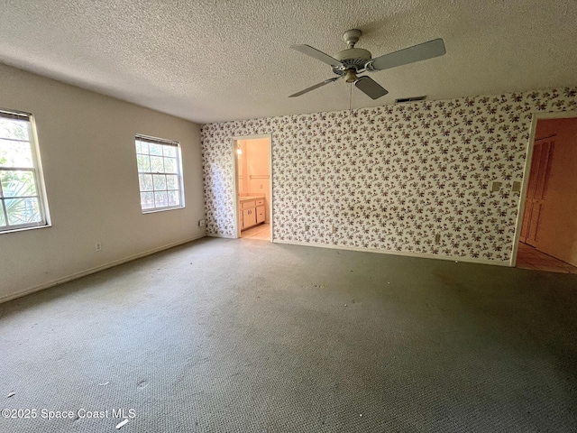 spare room featuring ceiling fan and a textured ceiling