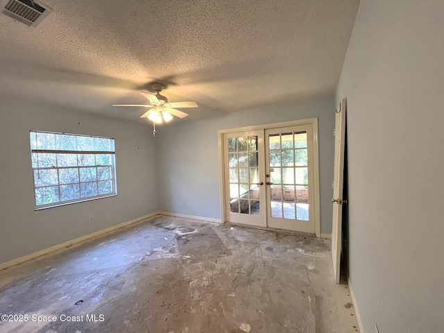 unfurnished room with ceiling fan, a textured ceiling, and french doors