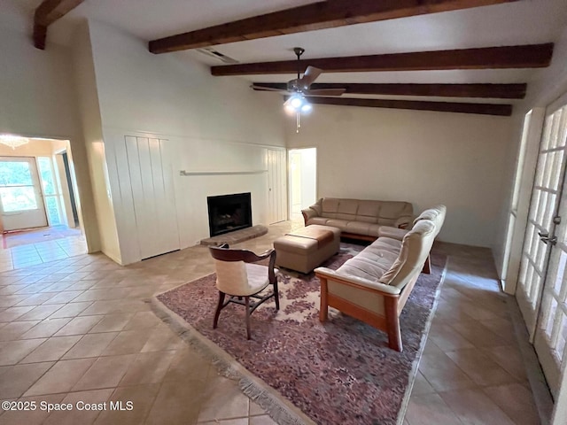 tiled living room featuring beam ceiling and ceiling fan