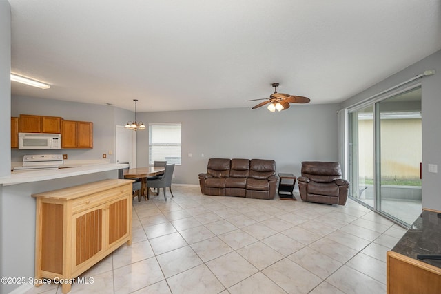 living room with light tile patterned flooring and ceiling fan with notable chandelier