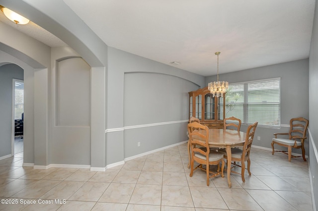 dining space featuring an inviting chandelier and light tile patterned flooring