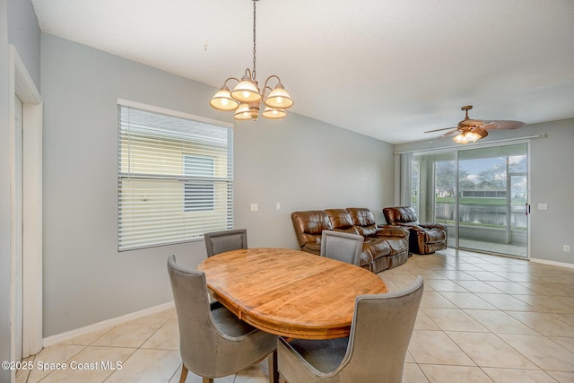 dining space with ceiling fan with notable chandelier and light tile patterned floors