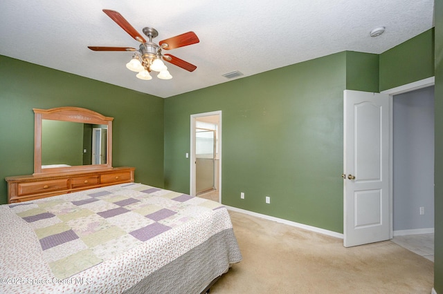 carpeted bedroom with ceiling fan and a textured ceiling