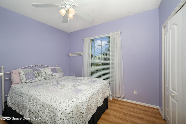 bedroom with ceiling fan and hardwood / wood-style floors