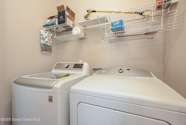 laundry room featuring washing machine and clothes dryer