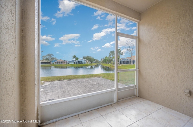 entryway featuring light tile patterned flooring and a water view