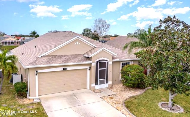 ranch-style house featuring a garage and a front lawn