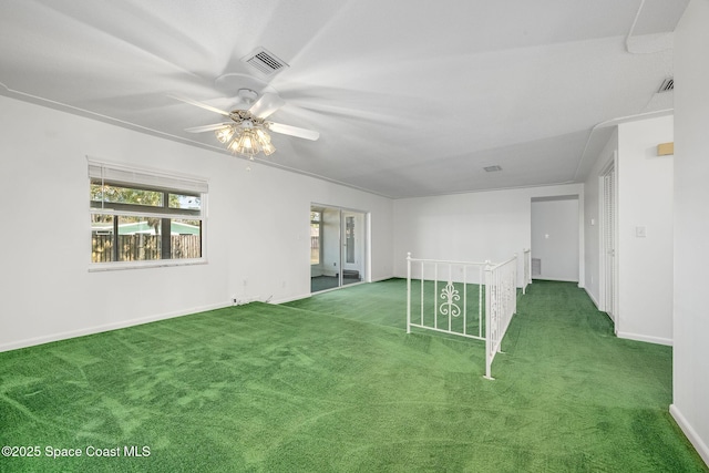 carpeted spare room with ceiling fan