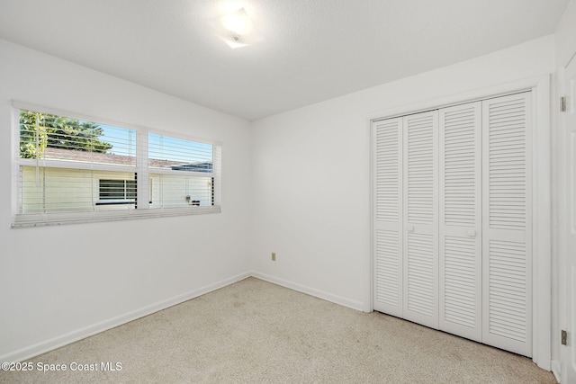 unfurnished bedroom with a textured ceiling and a closet