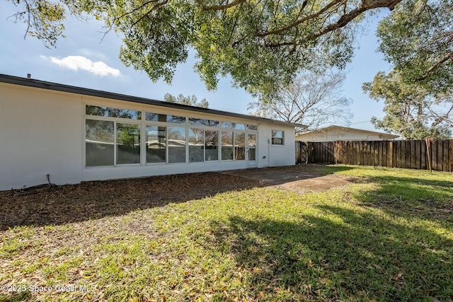 rear view of house with a yard