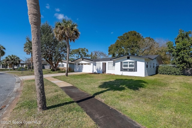 single story home featuring a garage and a front yard