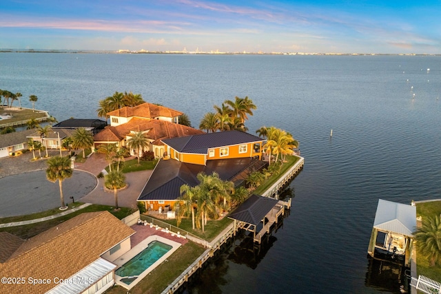 aerial view at dusk with a water view