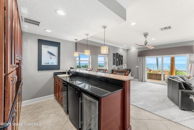 kitchen featuring crown molding, plenty of natural light, beverage cooler, and a textured ceiling