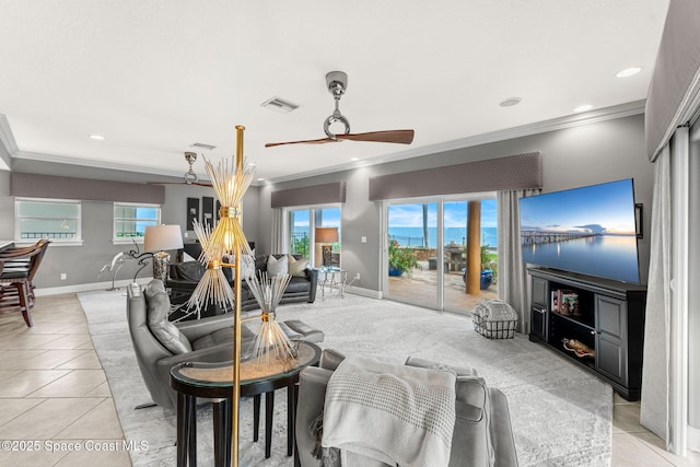 tiled living room with ceiling fan and ornamental molding