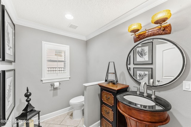 bathroom with vanity, ornamental molding, tile patterned floors, and toilet