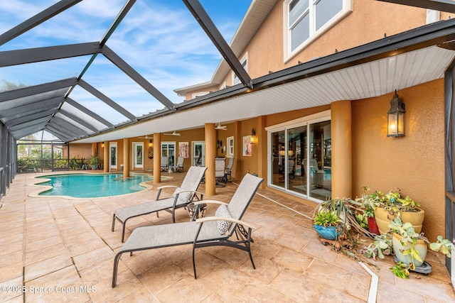 view of swimming pool featuring a patio, a lanai, and ceiling fan