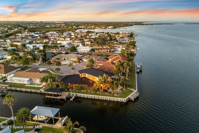 aerial view at dusk with a water view