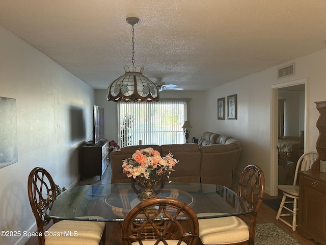 dining room with ceiling fan and a textured ceiling