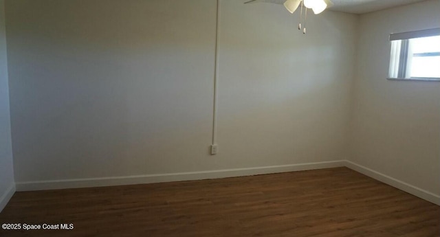 empty room featuring dark wood-type flooring and ceiling fan