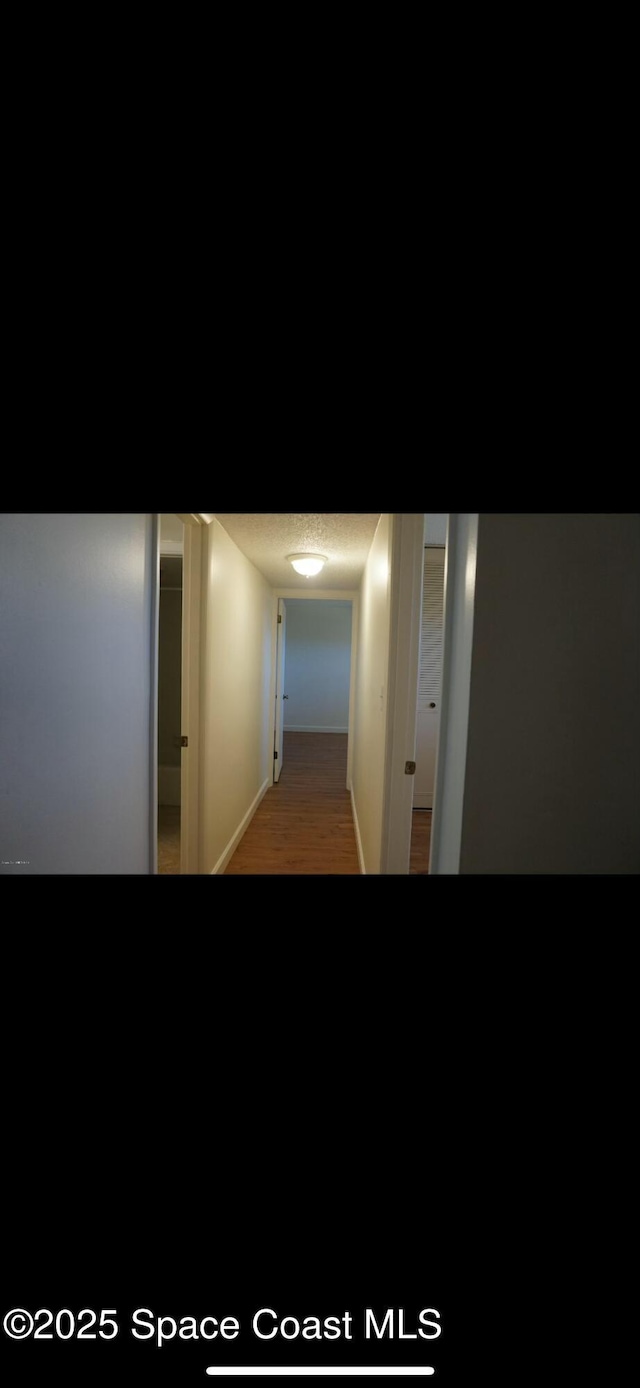 corridor with light hardwood / wood-style floors