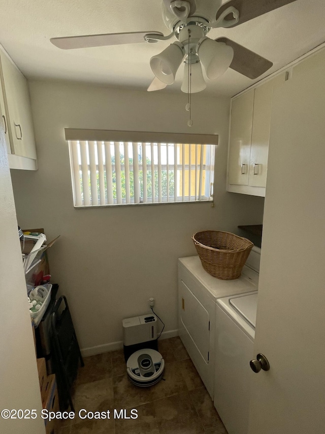 clothes washing area with cabinets, independent washer and dryer, dark tile patterned flooring, and ceiling fan