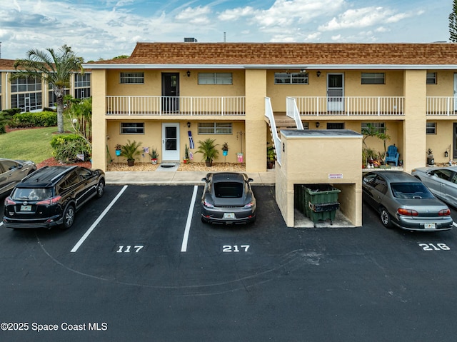 view of building exterior featuring uncovered parking