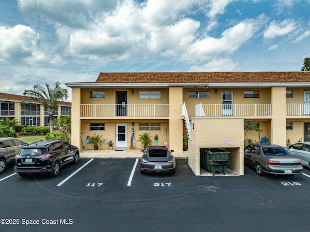 view of building exterior featuring uncovered parking