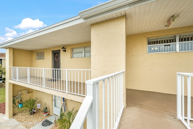 view of exterior entry featuring stucco siding