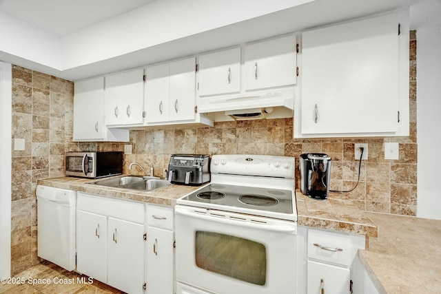 kitchen with tasteful backsplash, white appliances, under cabinet range hood, a sink, and white cabinets