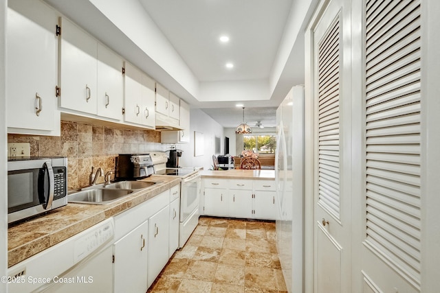 kitchen with white cabinetry, tasteful backsplash, recessed lighting, white appliances, and a sink