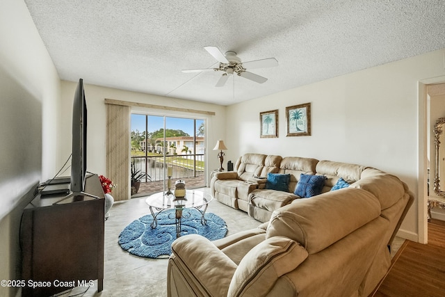 living area featuring a textured ceiling and ceiling fan