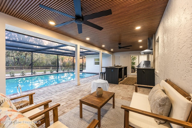 view of pool with ceiling fan, a lanai, an outdoor hangout area, and a patio area