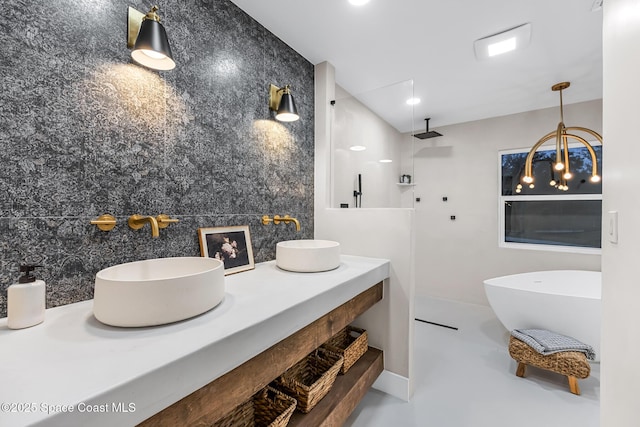 bathroom featuring vanity, concrete flooring, and shower with separate bathtub