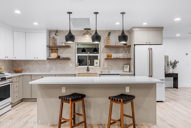 kitchen featuring hanging light fixtures, a center island, and white appliances