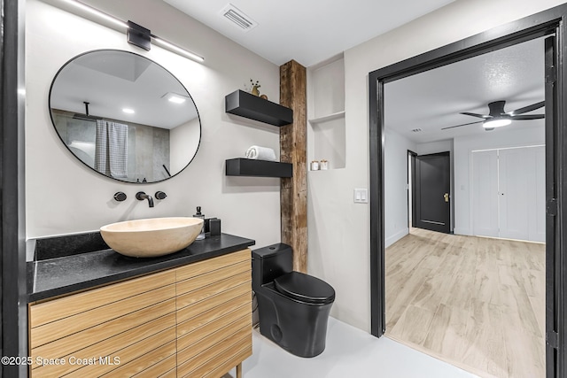 bathroom with ceiling fan, wood-type flooring, and vanity