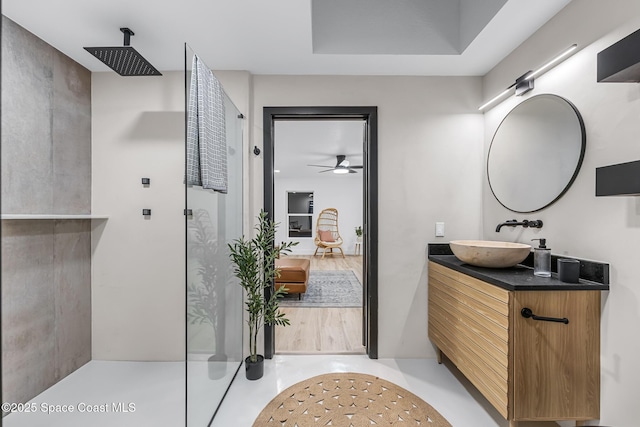 bathroom featuring walk in shower and vanity