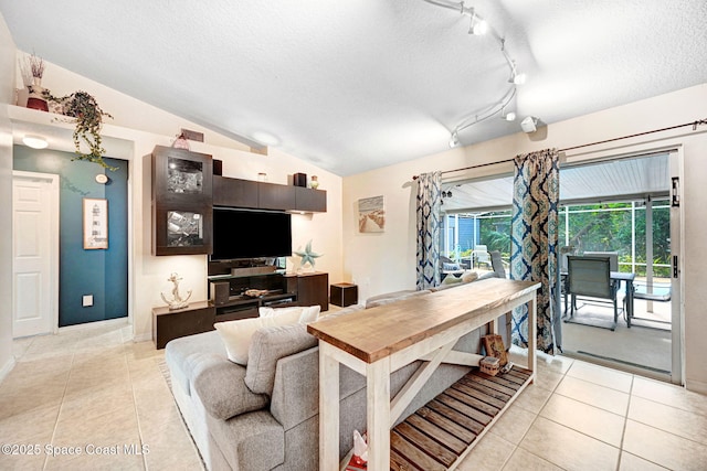 tiled living room featuring lofted ceiling and a textured ceiling