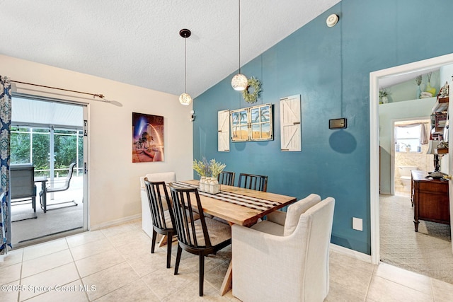 dining room with light tile patterned flooring, high vaulted ceiling, and a textured ceiling