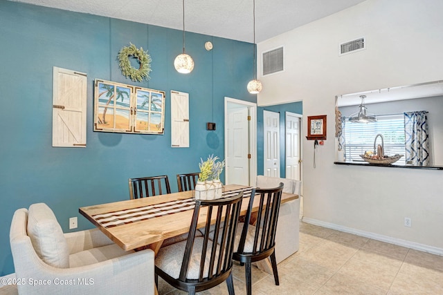 dining room featuring tile patterned floors and a high ceiling