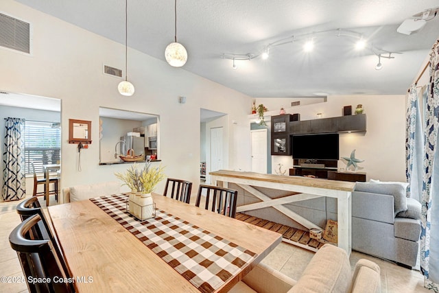 dining space with vaulted ceiling