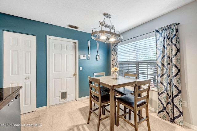 dining area featuring light tile patterned floors